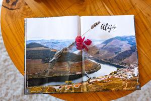 a book with a flower on the top of it at Mourisco Guest House in Alijó +12 photos
