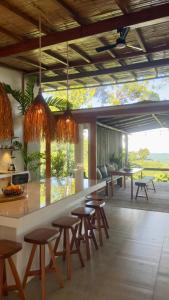 a room with a bar with stools and tables at Wild Wasi - Private Jungle Villa in Puyo +63 photos