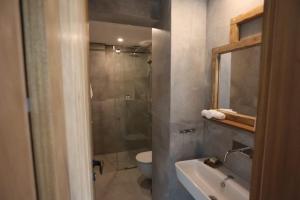 a bathroom with a shower and a sink and a toilet at Villa Paradiso Batroun in Batroûn