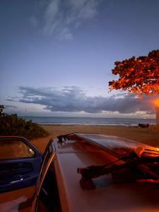 a car parked on the beach with the view of the ocean at Joe's Studio in San Juan