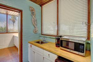 a kitchen with a sink and a microwave on a counter at Beachhead Unit 5 BH5 in Port Aransas
