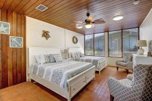 a bedroom with two beds and a ceiling fan at Beachhead Unit 5 BH5 in Port Aransas +50 photos