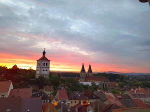 a view of a city at sunset with buildings at Elbe Stay Roudnice in Roudnice nad Labem