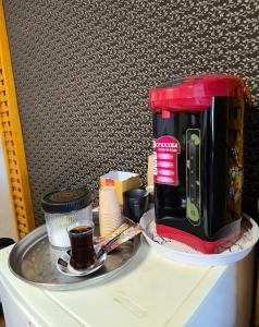 a coffee maker sitting on top of a refrigerator at HERSH Palace Hotel in Erbil