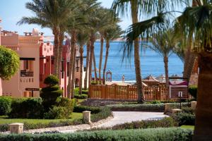 a resort with palm trees and the ocean in the background at Charmillion Sea Life Resort in Sharm El Sheikh
