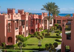 arial view of a building with palm trees and bushes at Charmillion Sea Life Resort in Sharm El Sheikh