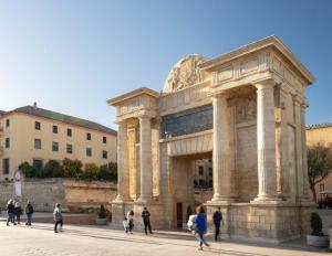 a group of people walking in front of a building at Cordoba Calle Pozanco in Córdoba +10 photos