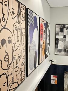 a group of drawings on a wall in a room at Transamerica Executive Bela Cintra (Paulista) in São Paulo