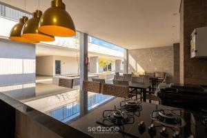 a kitchen with a stove and a dining room at Apts in a Building with Pool and Gym - GRL in Anápolis