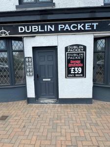 a building with a door and a sign on it at The Dublin Packet- Single Room 7 in Holyhead