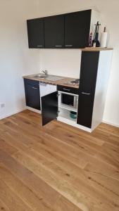 a kitchen with a counter with a microwave in it at S3 Stadl Paura in Stadl-Paura