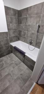 a bathroom with a bath tub with a shower at S3 Stadl Paura in Stadl-Paura