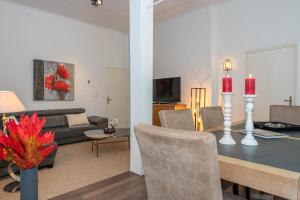 a living room with a dining room table and a couch at Zwaluwenburg 8 in 't Harde