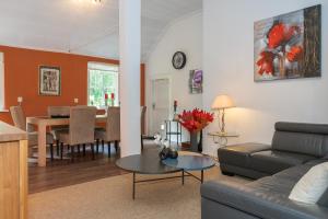 a living room with a couch and a table at Zwaluwenburg 8 in 't Harde