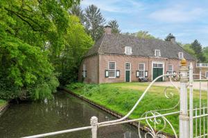 a house with a hose connected to a river at Zwaluwenburg 8 in 't Harde +28 photos
