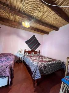 a bedroom with a bed in a room at Kantuta Hospedaje in Tilcara +3 photos