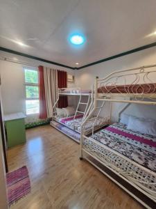 two bunk beds in a room with wooden floors at Aquatico Royalle Private Resort in Calamba +40 photos