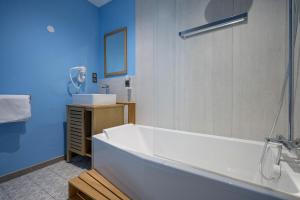 a bathroom with a white tub and a sink at Domaine du Béron - Chateau et gites in Cappelle-en-Pévèle +70 photos