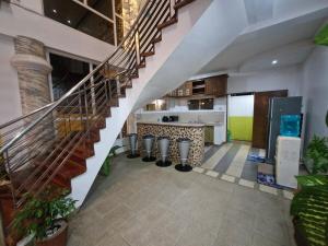 a kitchen with a staircase in a house at Aquatico Royalle Private Resort in Calamba
