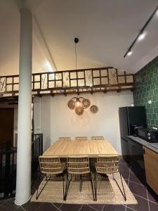 a table and chairs in a kitchen with a chandelier at Casa D'Avó Carmen in Ventosa +19 photos