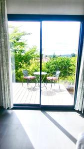 a view of a patio with two chairs and a table at Sous le figuier in Marseille