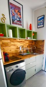 a kitchen counter with a sink and a stove at Sous le figuier in Marseille