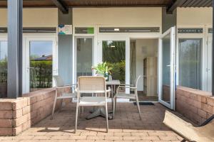 a patio with a table and chairs on it at Zamárdi Parti Apartman in Zamárdi