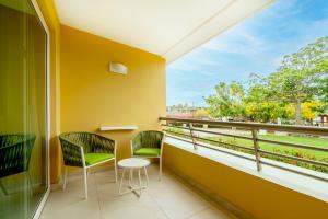 a balcony with two chairs and a table at Iberostar Selection Playa Mita - All Inclusive in Punta Mita +123 photos