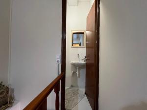 a hallway to a bathroom with a sink and a toilet at La Dimora di Basilica in Ágios Matthaíos +17 photos