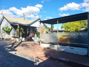 a building with a fence in front of it at The wood Guest house in Pretoria