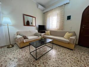a living room with a couch and a table at La Dimora di Basilica in Ágios Matthaíos