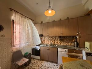 a kitchen with a sink and a stove top oven at La Dimora di Basilica in Ágios Matthaíos