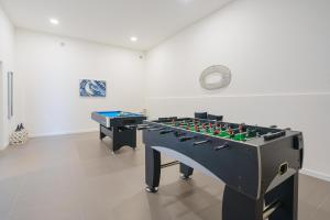 a room with a foosball table in front of a wall at Villa Emilio with private pool in Mariquiteira