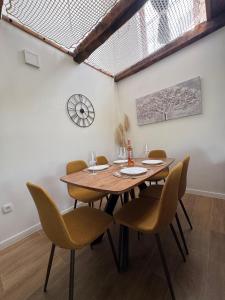 a dining room with a wooden table and chairs at La casa de Nora in Duga Resa +18 photos