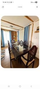 a dining room with a dining table and chairs at Cabaña kobata in Villa Mills +34 photos