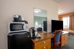 a room with a desk with a microwave and a computer at Wonder View Inn - Bar Harbor Collection in Bar Harbor