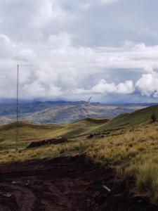 a view of a field with mountains in the background at Apu Tacllo lodge in Layo