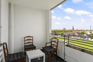 a balcony with chairs and a view of the city at MK Apartment Delmenhorst nähe Bremen 21 in Delmenhorst