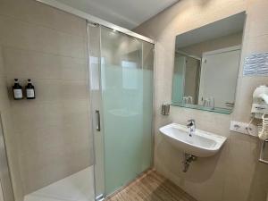 a bathroom with a shower and a sink at Hostal del Mar in Tossa de Mar