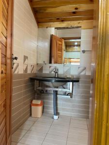 a bathroom with a sink and a mirror at Hillside Cottages, Kala Bagh in Nathia Gali +115 photos