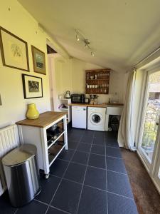 a kitchen with a sink and a stove top oven at The Old Barn in Farthinghoe