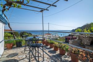 a balcony with a view of the ocean at Sofia's Sea View House in Ágios Dimítrios