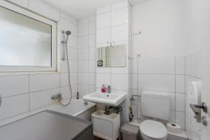 a white bathroom with a sink and a toilet at MK Apartments Delmenhorst nähe Bremen 20 in Delmenhorst