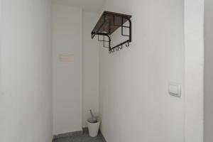 a shelf on the wall of a room with a table at MK Apartments Delmenhorst nähe Bremen 20 in Delmenhorst