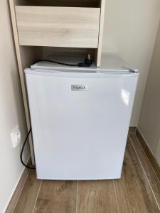 a white refrigerator in a room with a drawer at L’oliveraie in Robion en Luberon