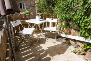 a white table and chairs on a patio at Viosinho guest house in Alijó +16 photos