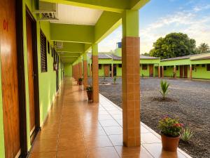an empty hallway of a school building with plants at Hotel Natureza in Anhanduí