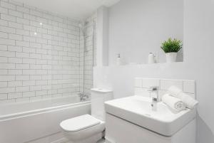 a white bathroom with a toilet and a sink at Central Birmingham 2 BED Modern Spacious Apartment in Birmingham