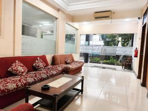 a living room with a couch and a table at Scarlet Hotel Stasiun Bandung in Bandung