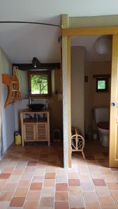 a bathroom with a sink and a toilet in a room at gite art et nature in Thorigny